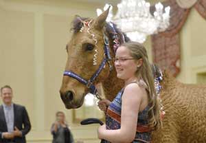 Carly Dahlkemper, 12, left, thanks Denise Olczak, executive director of Mystic Mountain Training Center, for helping grant her wish of horse Emmy during a Make-A-Wish Greater Pennsylvania and West Virginia event inside the Ambassador Center ballroom in Summit Township on Wednesday. Dahlkemper, who also received riding gear, has been riding Emmy at the center and has created a bond with the animal. Diagnosed with a respiratory and digestive disorder, she said she was surprised to learn that her wish had been granted. [GREG WOHLFORD/ERIE TIMES-NEWS]