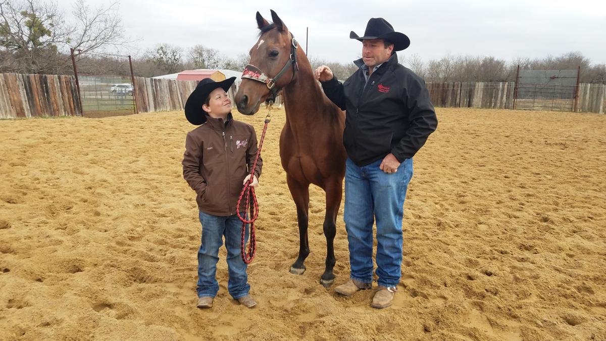 Aden Bernhagen, Dr Cuzin, and Casey Crouch share a moment after Aden's December victory at the National Cutting Horse Association World Finals. Daily Sun photo/Guy Chapman