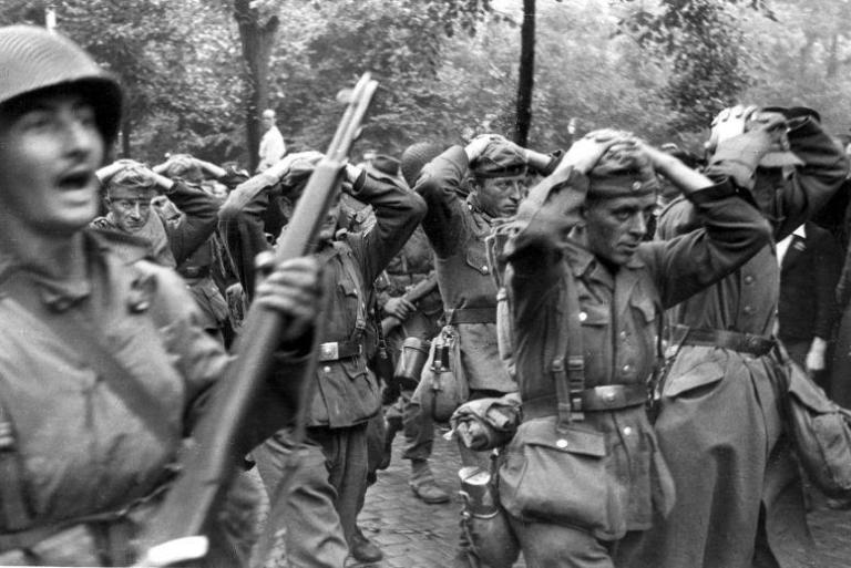 Surrendered German soldiers would be rearmed by the Americans to help defend the herd as it made for the American lines. (Image source: Flickr)